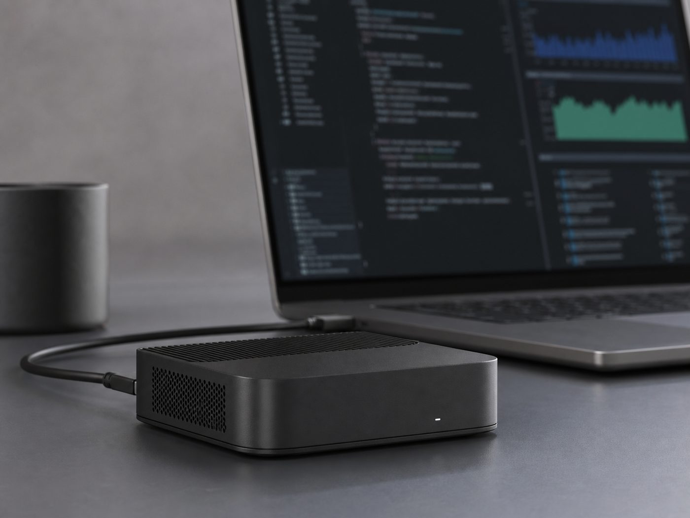 gpuvera terminal beside a laptop running a local model console and dashboard on a desk — concept render, pre-production.